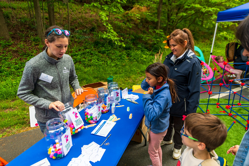 Children participate in activity at booth