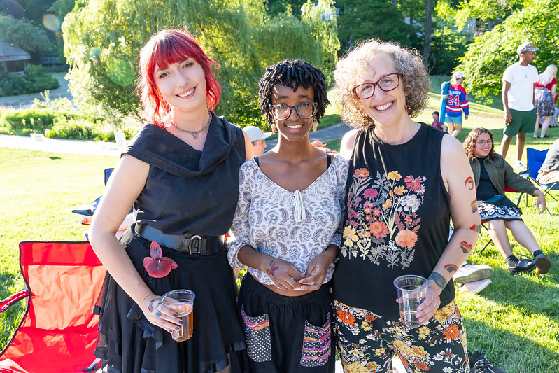 Three attendees smile at camera