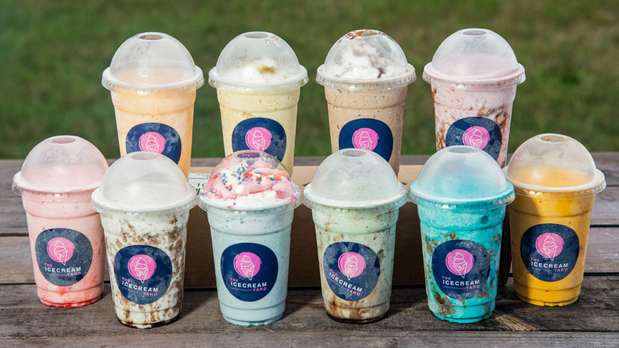 A variety of milkshakes in branded cups that say "The Icecream Yard".