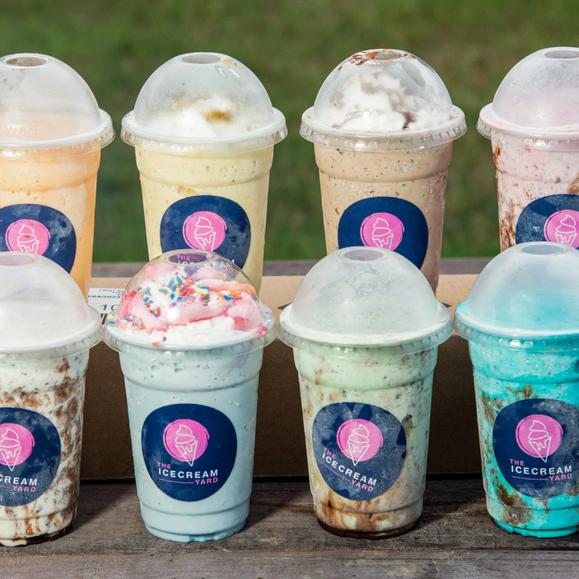 A variety of milkshakes in branded cups that say "The Icecream Yard".