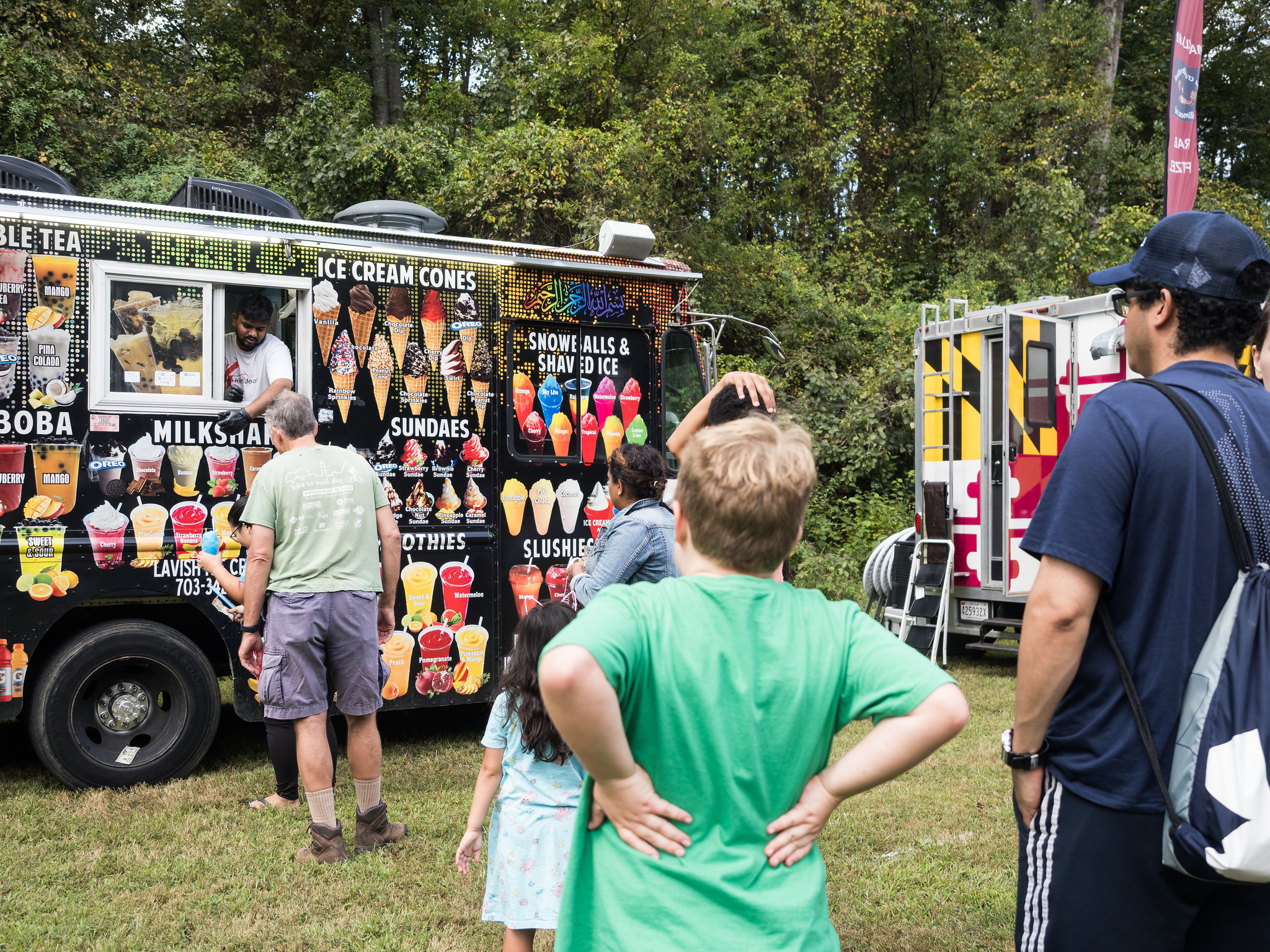 Guests wait in line at a food truck.
