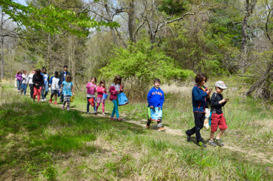 Kids walking on a natural surface trail in a park