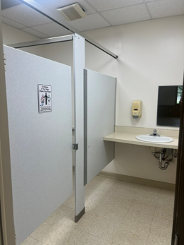 A picture of two stalls and a sink