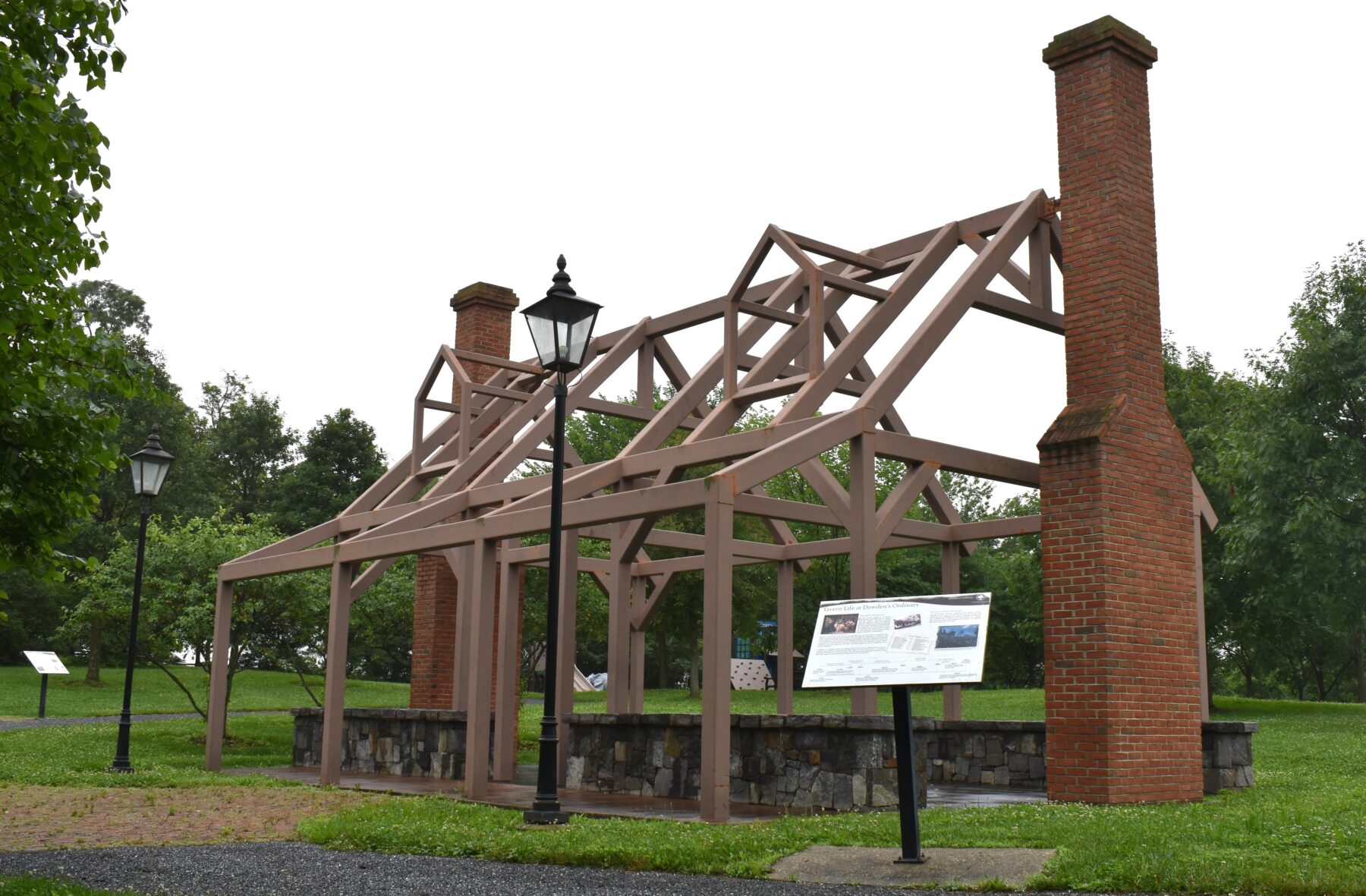 ghost structure of what the tavern used to look like. one and a half story frame buildings with a chimney in each gable end and front porch